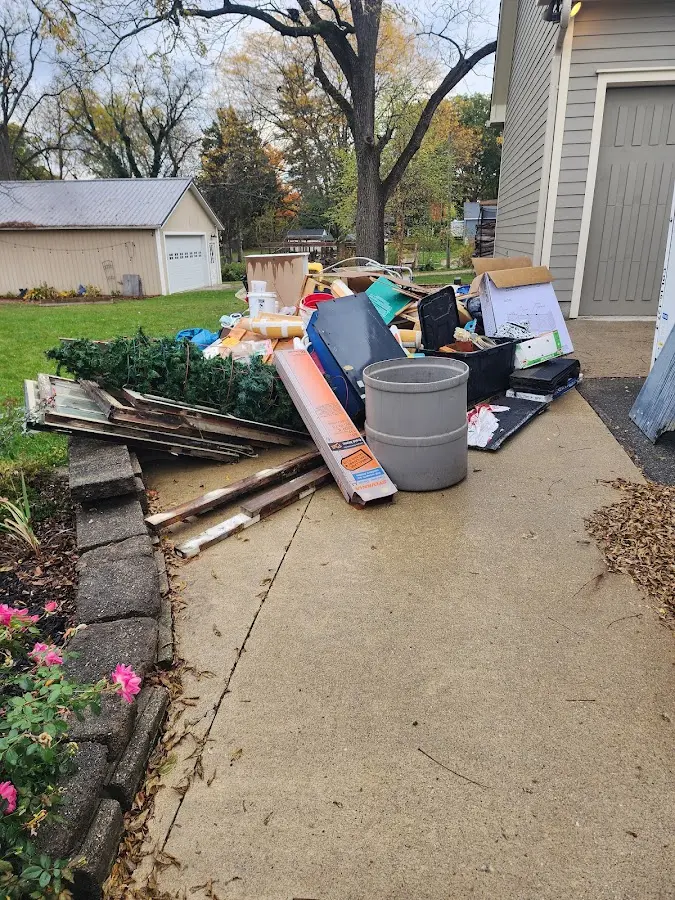 Dumpster being loaded with debris for Roofing Dumpster Rental in Cumberland